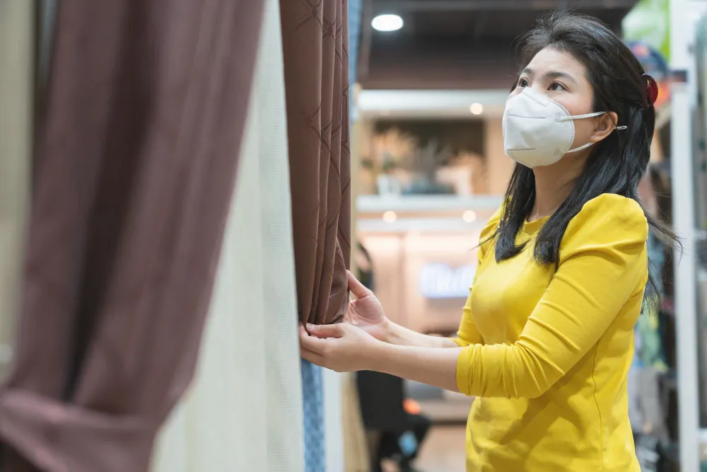 lady with mask dustry curtain with allergens