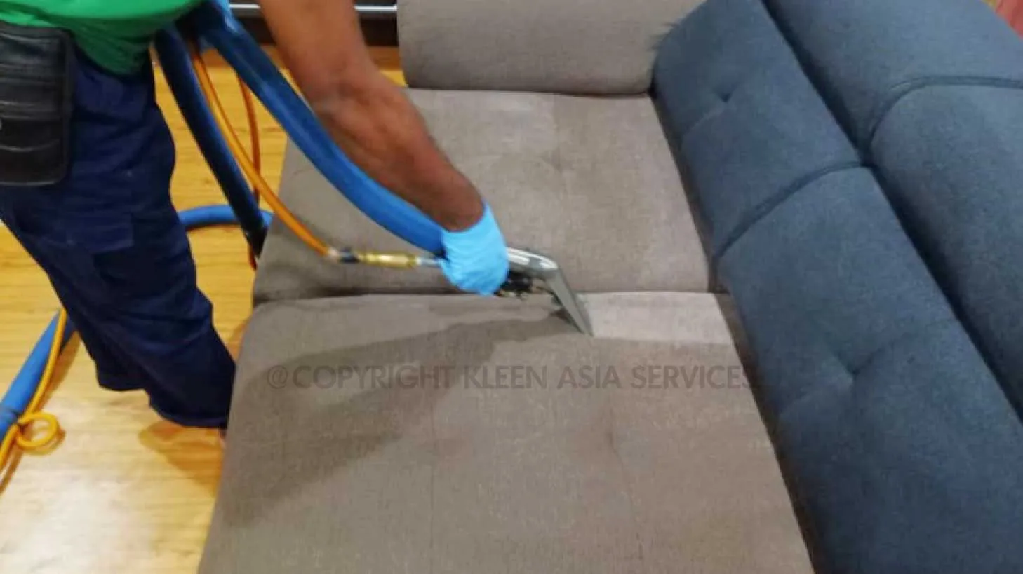 technician cleaning sofa